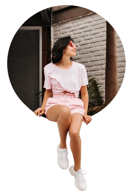 outdoor-shot-pensive-woman-casual-attire-pretty-tanned-young-woman-sneakers-sitting-bricked-wall-1-scaled